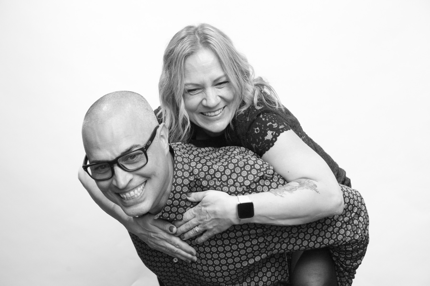 A couple share a playful piggyback pose